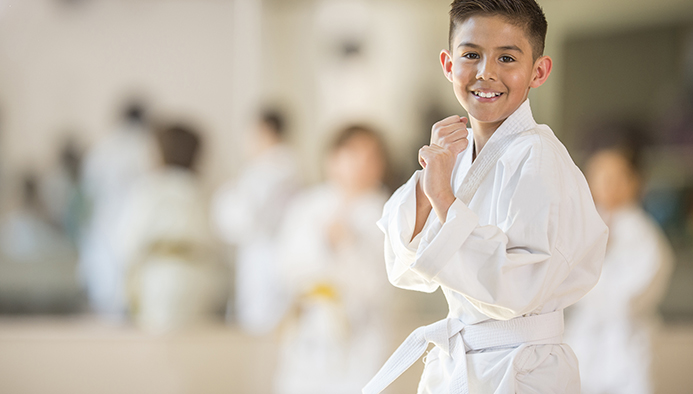 little boy taking karate